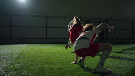 young women playing indoor soccer