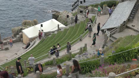 people visiting an outdoor amphitheater by the ocean