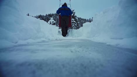 Massive-Snow-Covered-The-Ground,-Person-Sled-Shoveling-During-Winter-In-Trondheim,-Norway