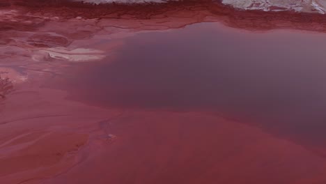 red artificial lake as cause of toxic aluminum waste