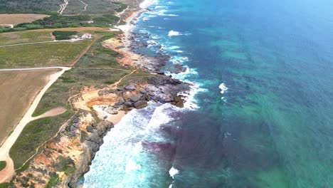 aerial-view-of-rugged-coast-,-blue-waves,-4k