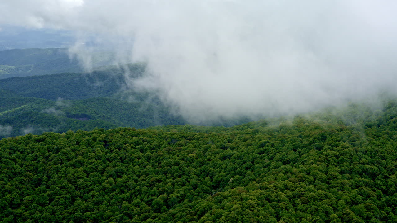 Fog and rain merge in this wide drone shot of the wild Smokies