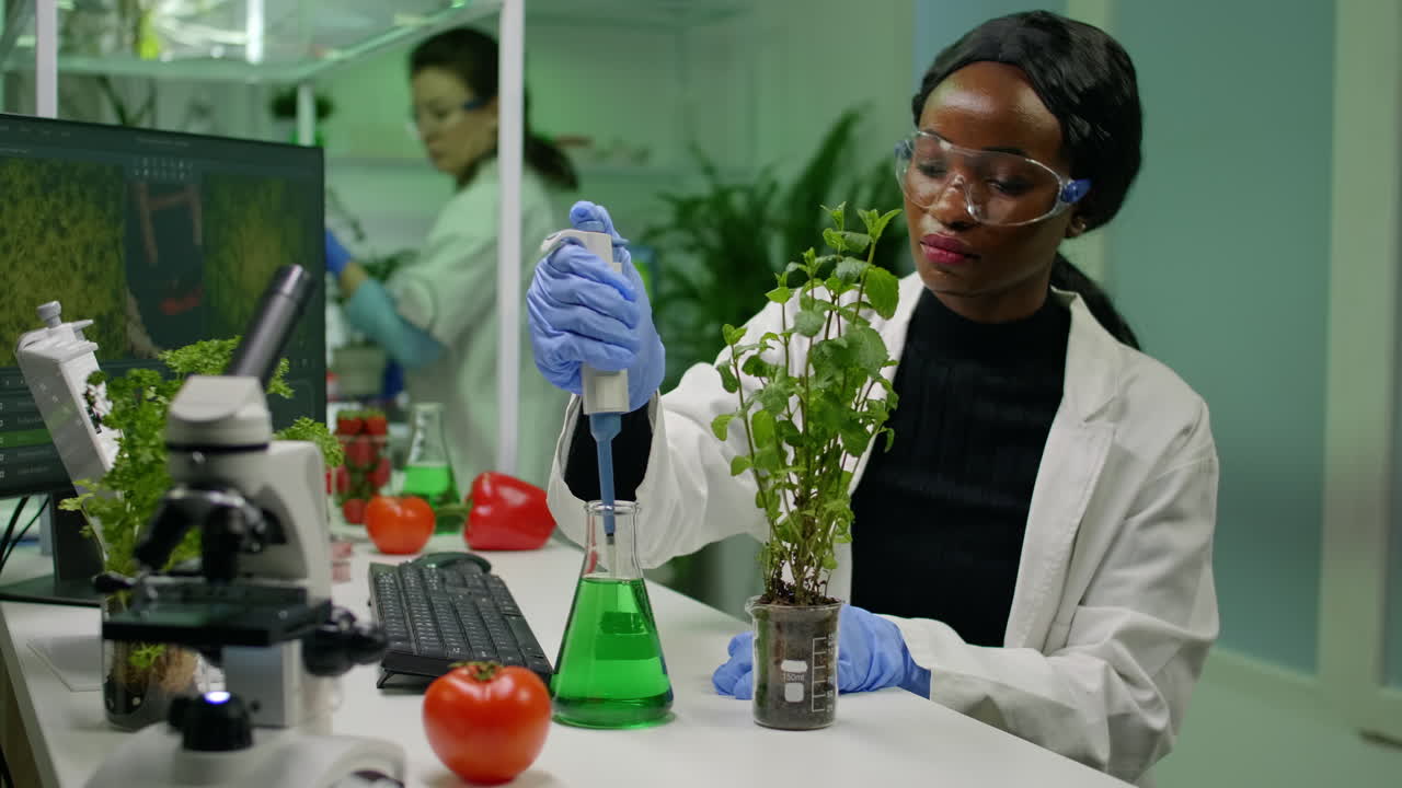 African botanist researcher taking genetic solution from test tube