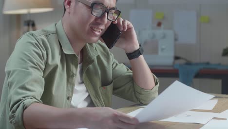 man talking on phone in a home office