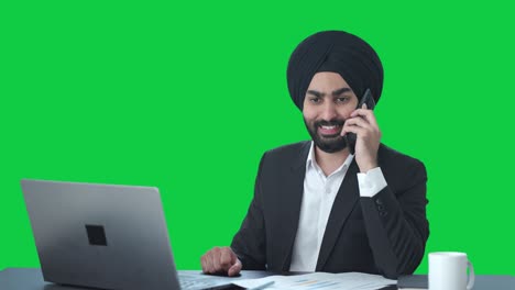 Happy-Sikh-Indian-businessman-talking-on-call-Green-screen