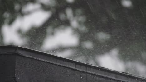 hard rain falls on tip of black roof