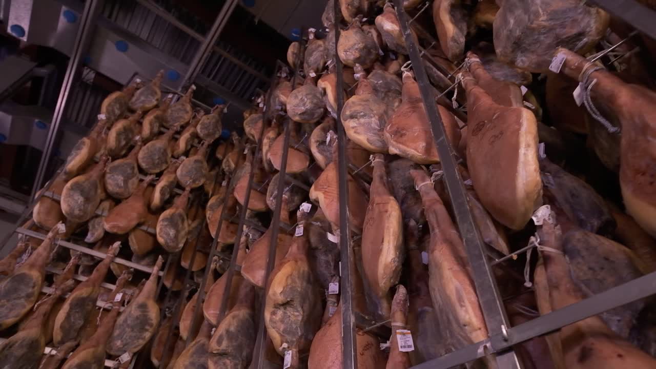 Jamon serrano pig legs factory hanging in a industry. Iberian ham elaboration process