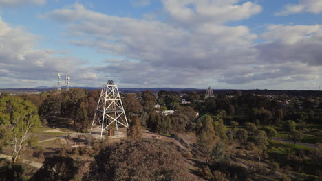 Wide circling drone shot of Victoria Hill Mining Reserve poppet head in Bendigo