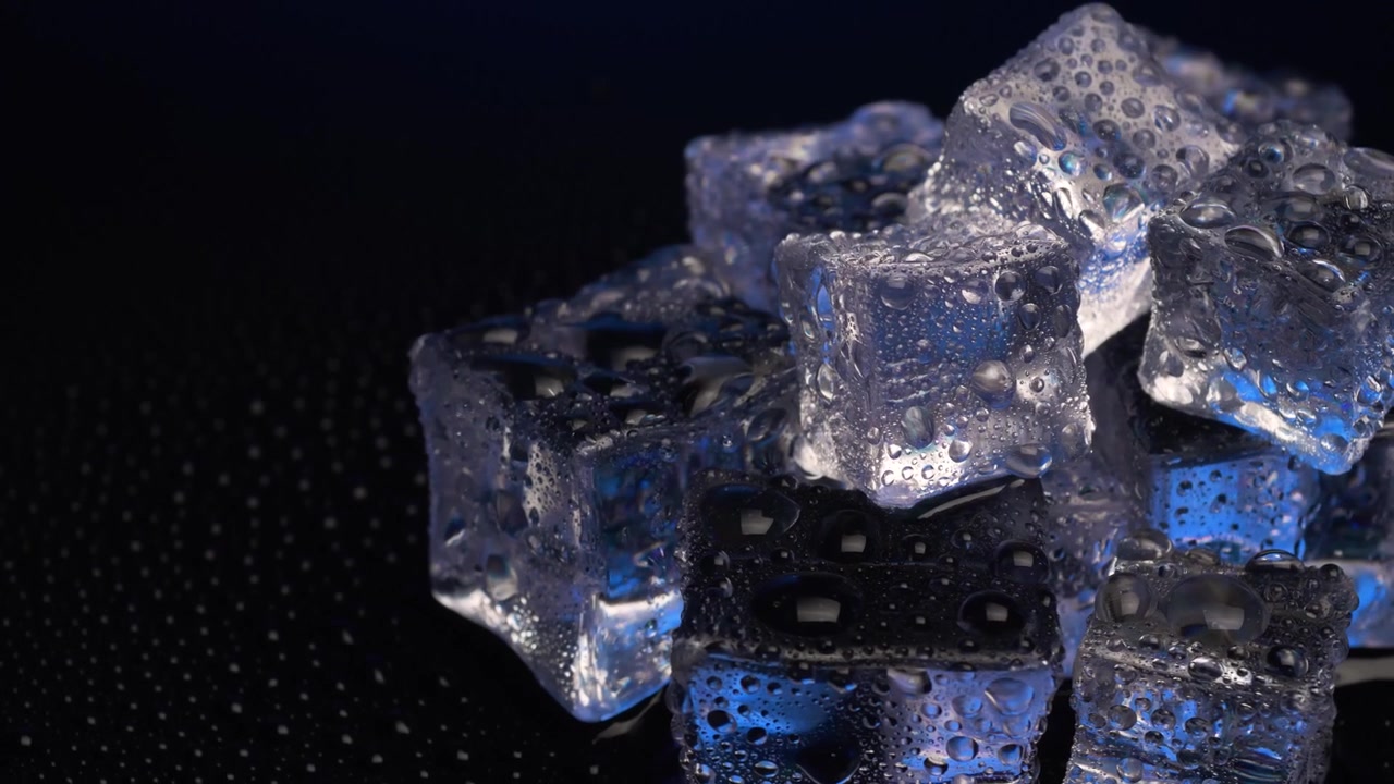 Primo piano di cubetti di ghiaccio che ruotano su sfondo nero