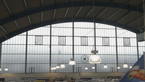 swansea indoor market panning shot with clock and stalls