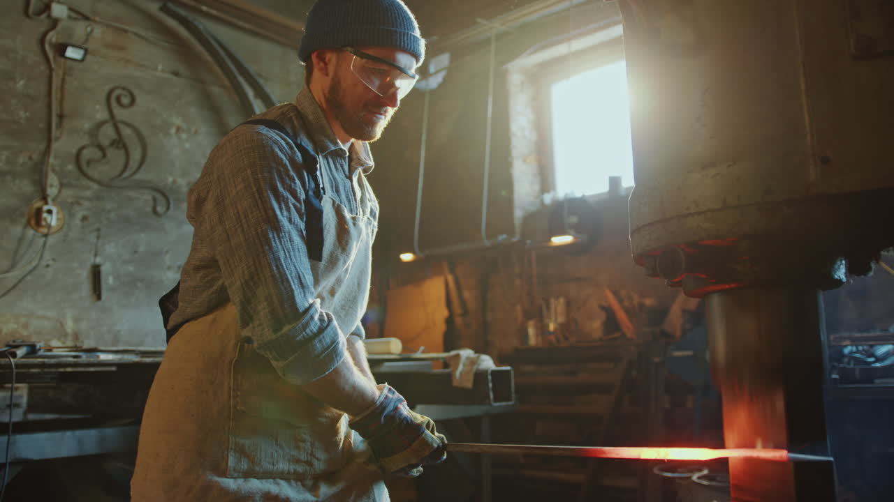 Blacksmith Forging Iron Rod with Hydraulic Press Machine in Workshop