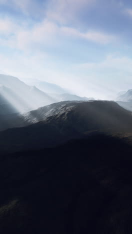 majestic mountain range with sunbeams breaking through the clouds