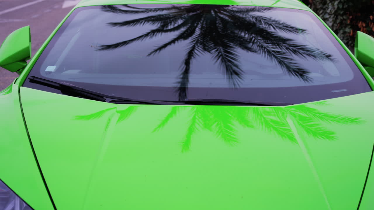 Close up of the front of a lime green car on the street
