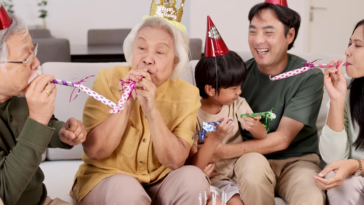 Elderly family member enjoys a lively birthday party with loved ones, surrounded by laughter, party hats, and festive decorations