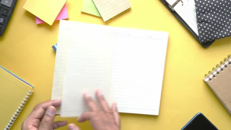 open notebook on yellow desk