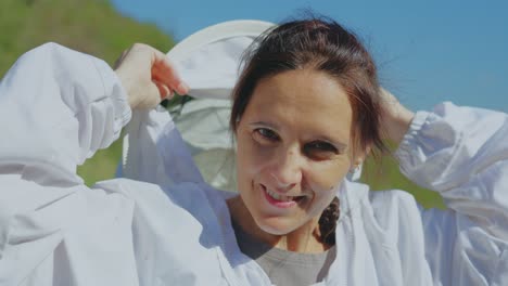 female beekeeper adjusting her protective suit