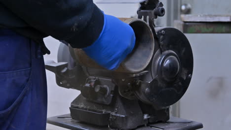 precision in progress: journeyman at work on bench grinder