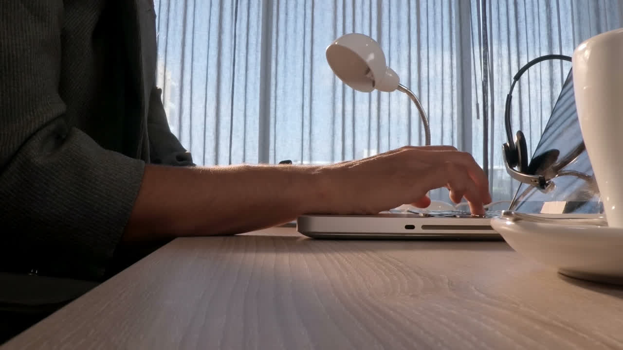Mid-section of female business executive using laptop
