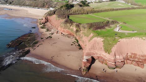 Toma-Panorámica-Aérea-Izquierda-De-Los-Acantilados-De-Orcombe-Point-Exmouth-Devon,-Inglaterra