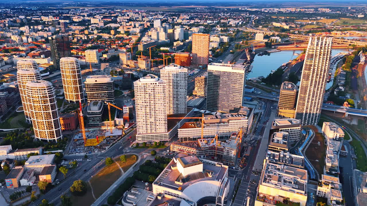 Flight over the modern urban landscape of Bratislava, Slovakia. Some new buildings being built in the sight. Aerial view