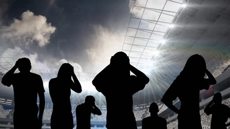 animation of silhouettes of disappointed sports fans over sports stadium