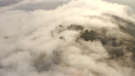 misty mountain top with building