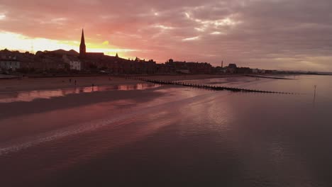 beautiful portobello beach in edinburgh during dramatic sunset- aerial drone view