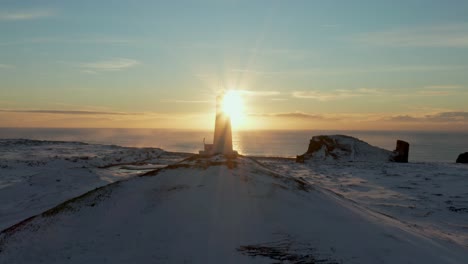 Silueta-Del-Faro-De-Reykjanes-Durante-La-Brillante-Puesta-De-Sol-En-Invierno-Islandia,-Antena