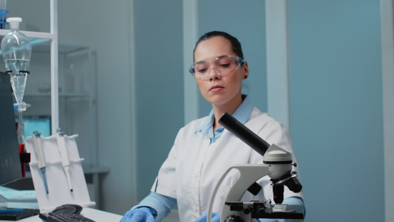 Scientist working in a lab with a microscope