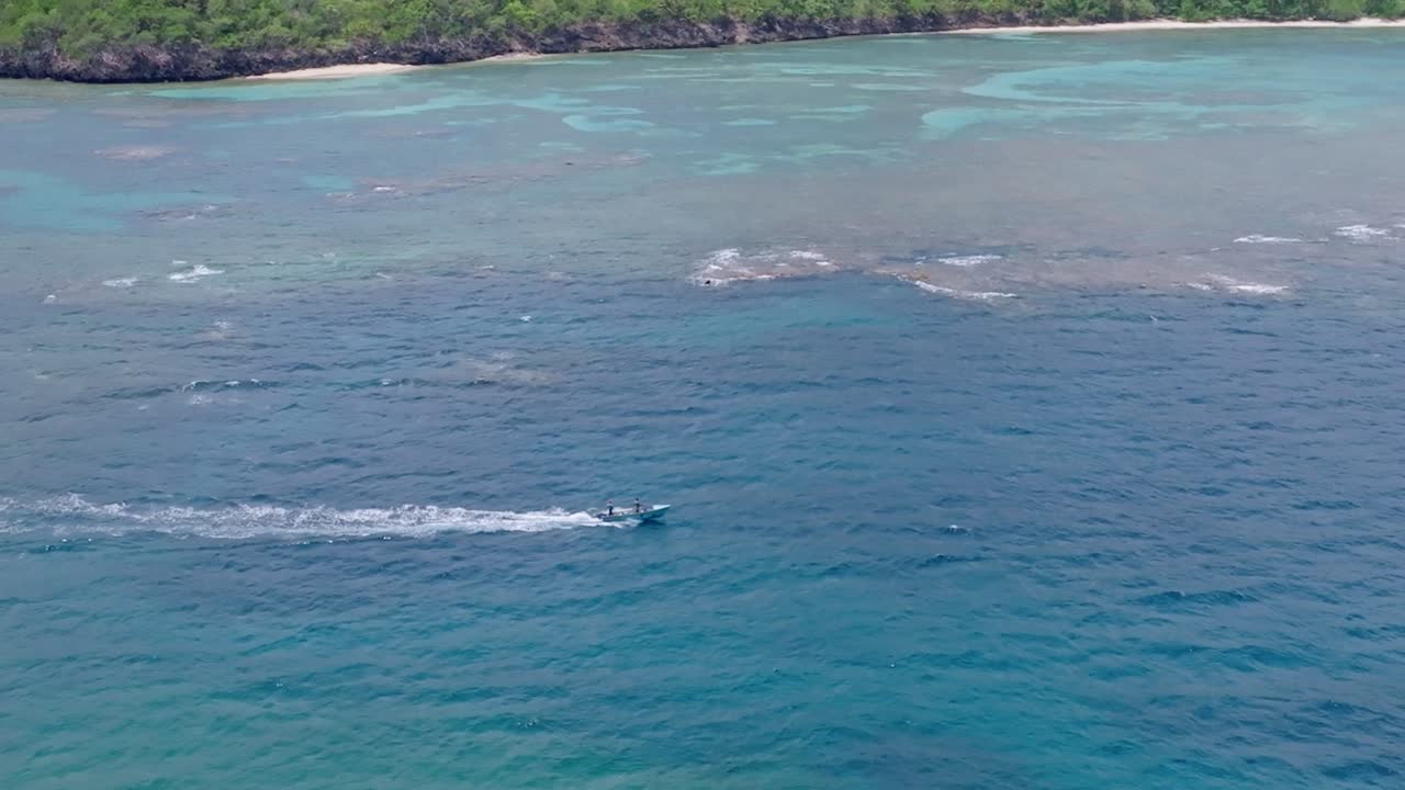 Drone flight over sailing boat on Playa Ermita&ntilde;o sea In Samana, Dominican Republic