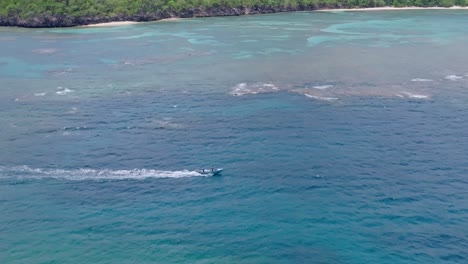 Drone-flight-over-sailing-boat-on-Playa-Ermitaño-sea-In-Samana,-Dominican-Republic