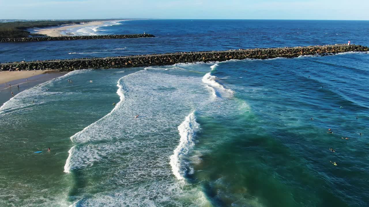 Flying north over waves ,Gold Coast dog beach and seawall at sunset