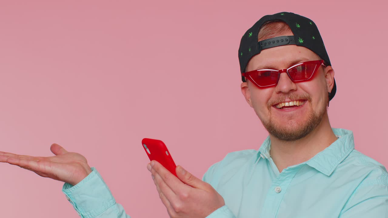 Man holding smartphone pointing empty place advertising area for commercial text goods promotion