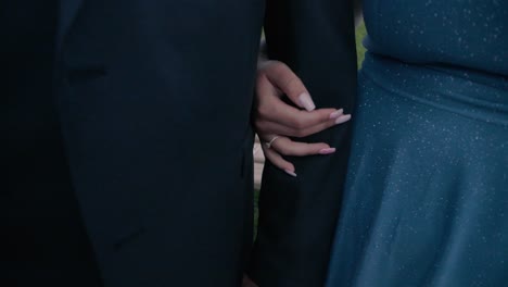 close up tilt shot of a bride and groom while the bride takes the groom's hand during a wedding