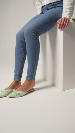 Close-Up-Vertical-Video-Of-Female-Social-Media-Influencer-Producing-User-Generated-Content-Putting-On-Beautiful-Pair-Of-Green-Shoes