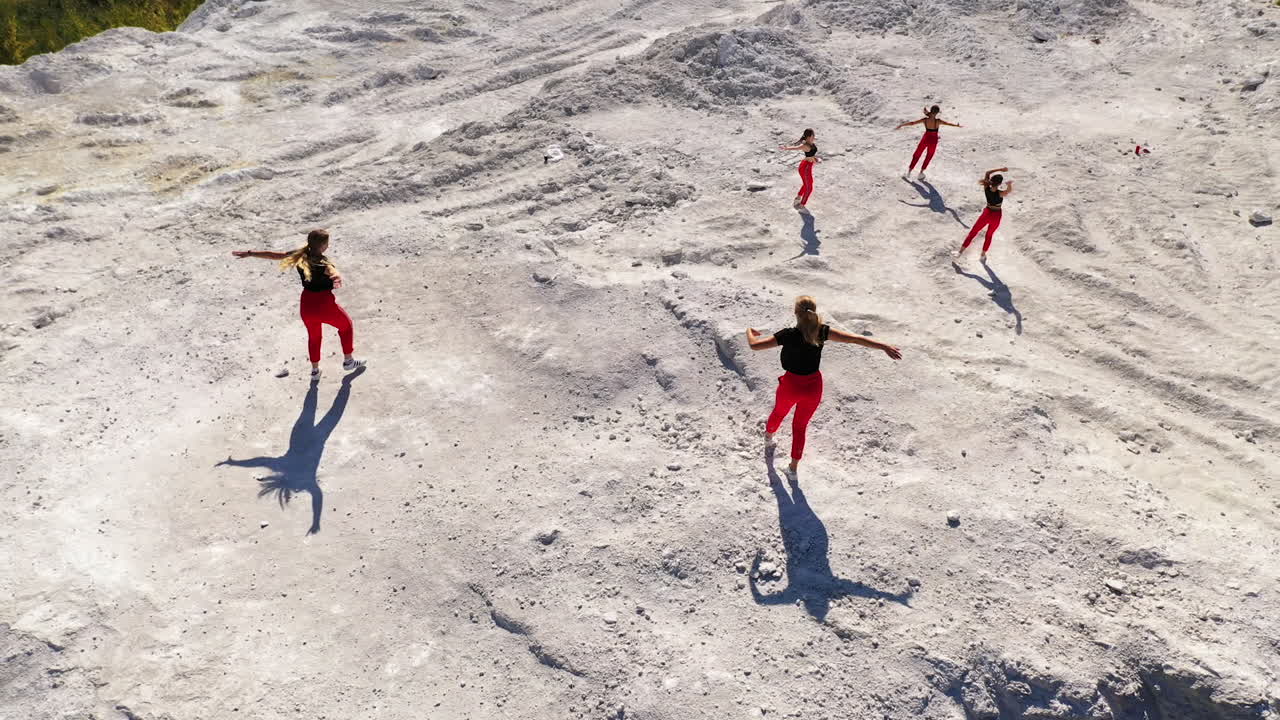 Women in Red Performing Contemporary Dance in a Quarry