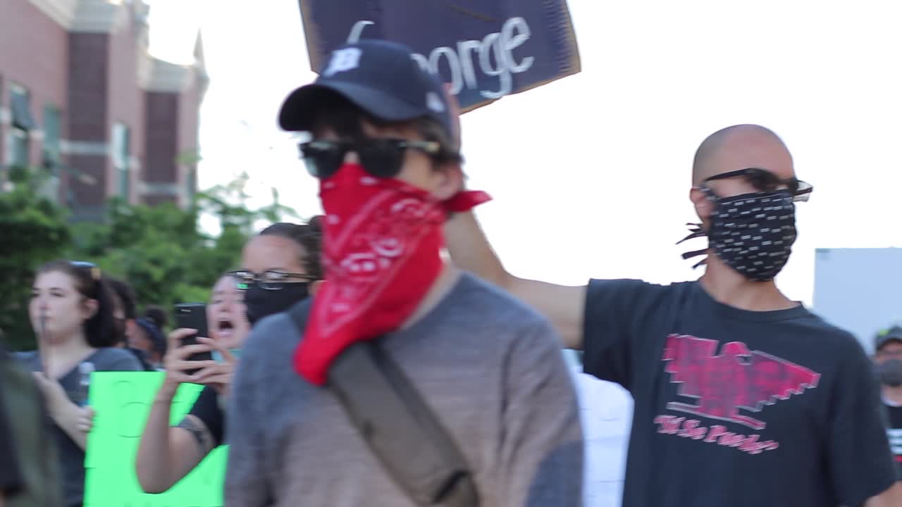 Justice for George placard sign in crowd at BLM demonstration march