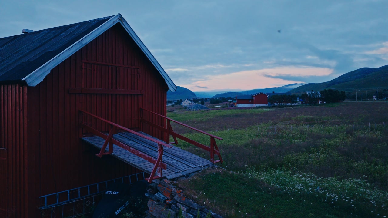 Kokelv, Hammerfest, Finnmark, Norway - The Peaceful Village Rests by the Shore, With Colorful Houses Dotting the Landscape - Drone Flying Forward
