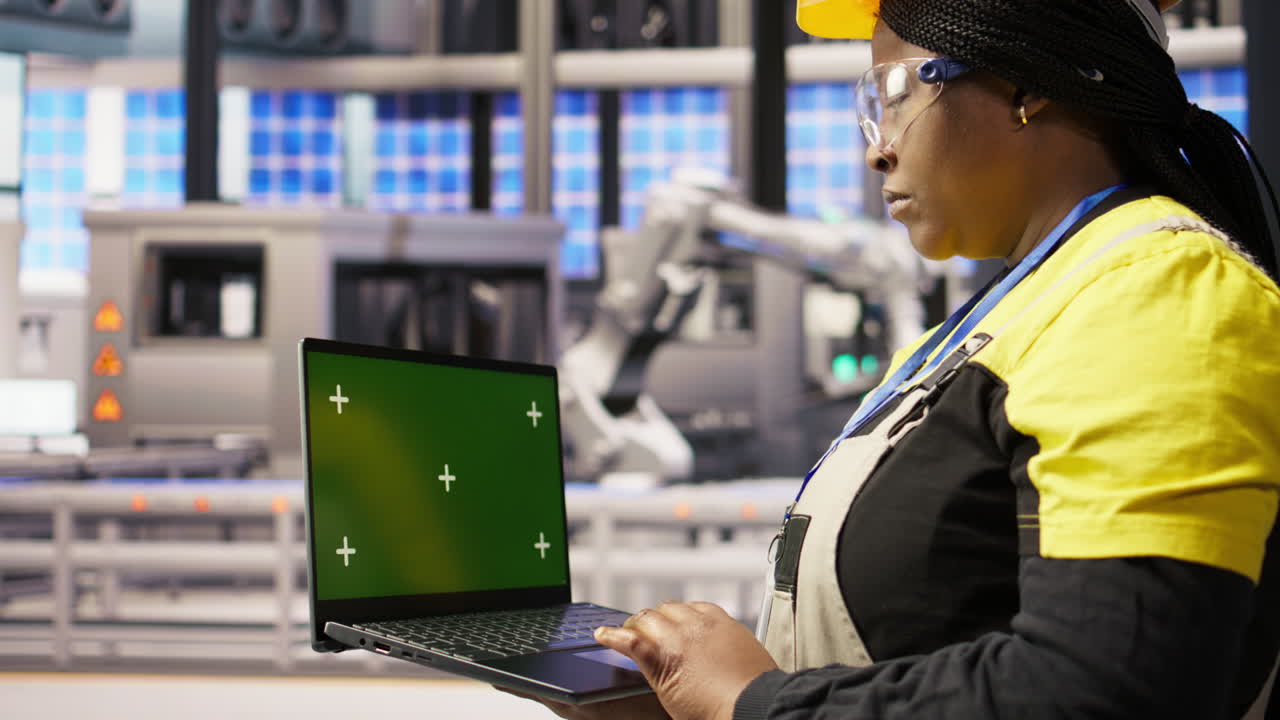 Vertical video Specialist using green screen laptop to conduct inspection in industry 4.0 plant
