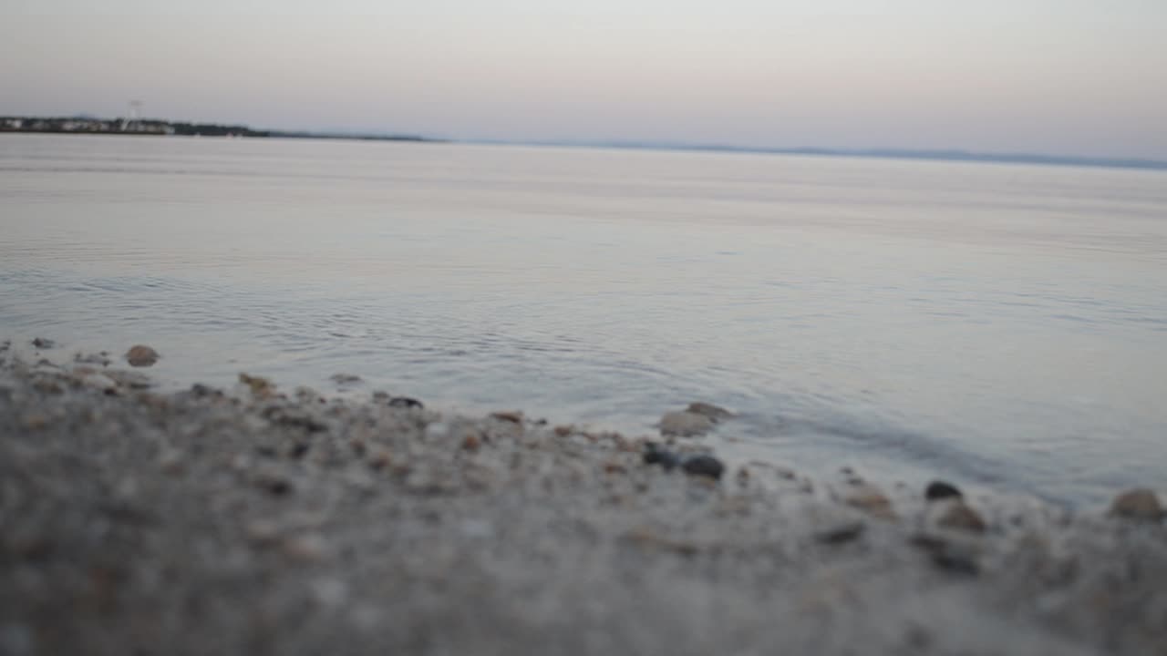 Small waves at beach during sunrise close up