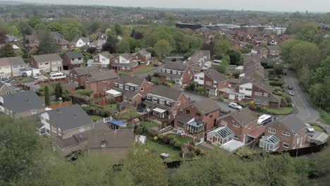 quiet british homes and gardens residential suburban property aerial view slow dolly right