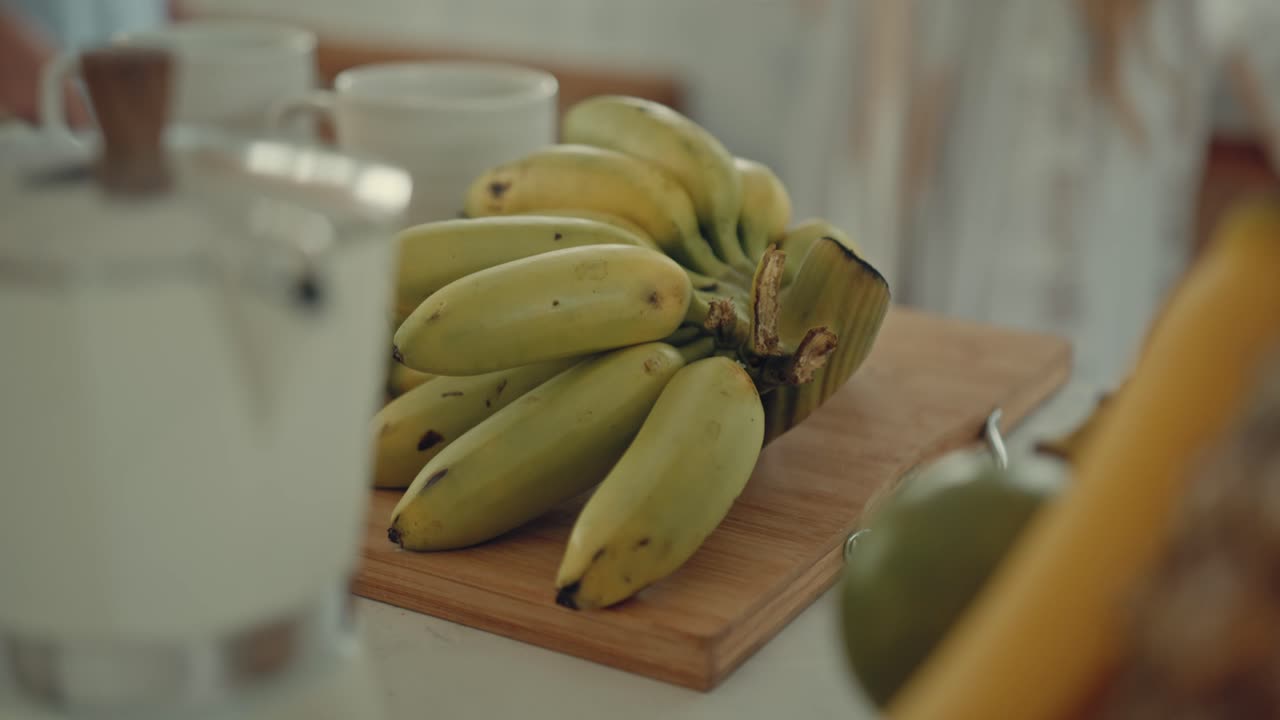 Bunch of Bananas on a Wooden Cutting Board