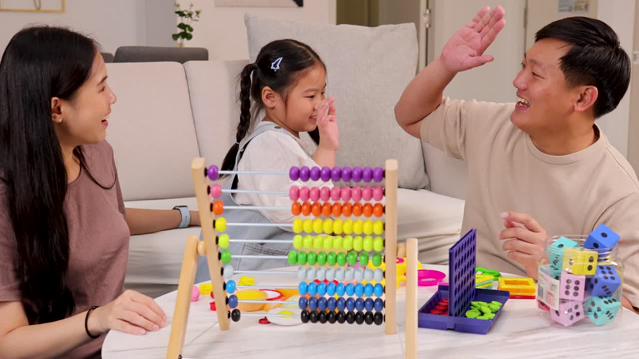 A family enjoys quality time using colorful educational toys in a cozy living room setting with warm lighting