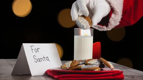 Animation-of-santa-claus-picking-cookies-over-orange-spots-of-light
