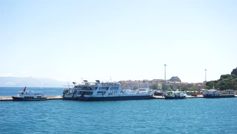 view from a sailing ferry of ships and ferries docked at the port on the island of corfu