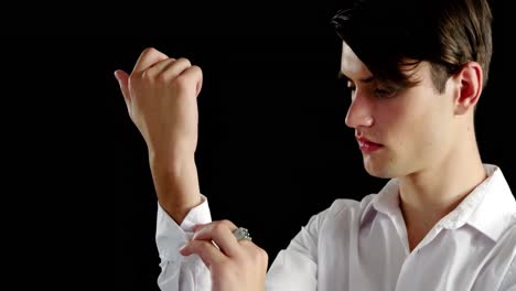 Androgynous-man-adjusting-his-hand-cuffs