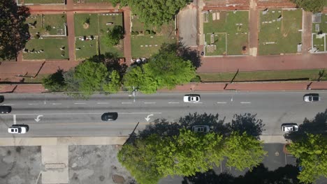 Aerial-nose-down-shot-of-a-cemetery,-with-tombs,-trees,-Georgia-clay,-and-intricate-street-patterns