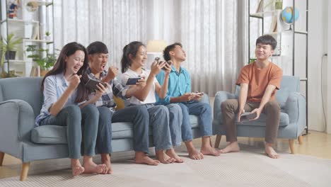 friends playing mobile games at home