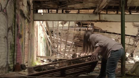 Woman-moving-rubble-and-debris-after-disaster