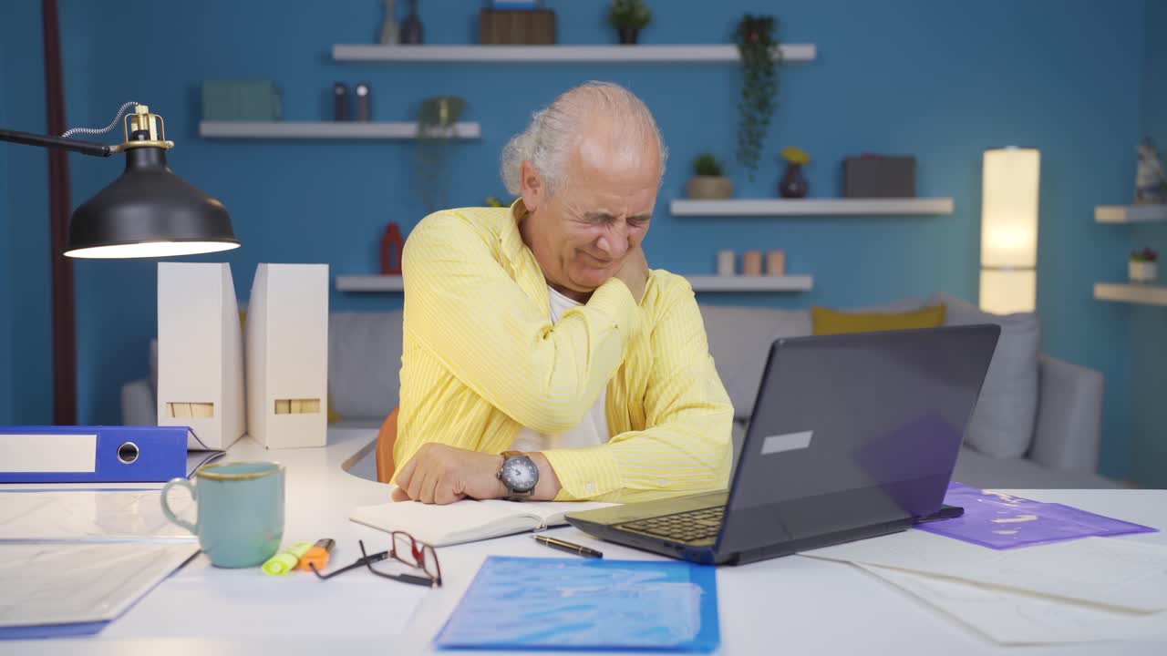 Home office worker old man has shoulder pain.